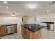 Open kitchen with stone countertops, stainless steel appliances, and wood cabinets at 15612 S Tuthill Rd, Buckeye, AZ 85326