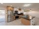 Modern kitchen featuring a black countertop island, stainless steel appliances, and ample cabinet space at 15612 S Tuthill Rd, Buckeye, AZ 85326