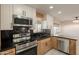 Well-lit kitchen featuring stainless steel appliances, marble countertops, and modern cabinetry at 15612 S Tuthill Rd, Buckeye, AZ 85326