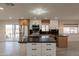 Open kitchen featuring stainless steel appliances, black countertops, and a large center island at 15612 S Tuthill Rd, Buckeye, AZ 85326