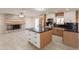 Spacious eat-in kitchen featuring modern stainless appliances, white brick fireplace and lots of natural light at 15612 S Tuthill Rd, Buckeye, AZ 85326