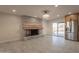 Open floor plan with modern brick fireplace and tile floors at 15612 S Tuthill Rd, Buckeye, AZ 85326