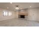 Bright living room with a decorative brick fireplace, tile floors, and lots of natural light at 15612 S Tuthill Rd, Buckeye, AZ 85326