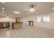 Bright, spacious living room featuring tile floors, recessed lighting, and a modern chandelier at 15612 S Tuthill Rd, Buckeye, AZ 85326