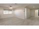 Open living area features neutral color scheme and view to the desert landscape outside at 15612 S Tuthill Rd, Buckeye, AZ 85326