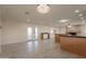 A spacious living room featuring neutral colors, recessed lights, and french doors at 15612 S Tuthill Rd, Buckeye, AZ 85326