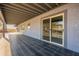 Covered patio with black tile featuring sliding door entry at 15612 S Tuthill Rd, Buckeye, AZ 85326
