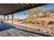 Covered patio with black tile and desert hillside view at 15612 S Tuthill Rd, Buckeye, AZ 85326