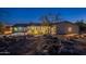 Desert home featuring charming rear exterior with a cozy patio and landscaped surroundings, illuminated at twilight at 15612 S Tuthill Rd, Buckeye, AZ 85326