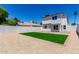 Two-story home backyard showing a green turf area and rock landscaping at 1605 W Curry Dr, Chandler, AZ 85224