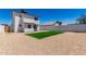 A spacious backyard featuring low-maintenance rock landscaping and a turf area at 1605 W Curry Dr, Chandler, AZ 85224