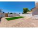 Backyard featuring a brick patio, rock landscaping and a turf area at 1605 W Curry Dr, Chandler, AZ 85224