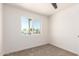 Bedroom featuring a ceiling fan, plush carpet, and large exterior window at 1605 W Curry Dr, Chandler, AZ 85224