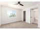 Bedroom featuring a ceiling fan, plush carpet, and exterior window at 1605 W Curry Dr, Chandler, AZ 85224