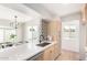 View of the kitchen, bar seating and dining area featuring sleek countertops, modern appliances, and stylish backsplash at 1605 W Curry Dr, Chandler, AZ 85224