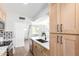 Spacious open-concept kitchen featuring sleek countertops, modern appliances, and adjacent staircase to upper level at 1605 W Curry Dr, Chandler, AZ 85224