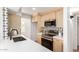 Well-equipped kitchen with sleek countertops, modern stainless steel appliances, and stylish backsplash at 1605 W Curry Dr, Chandler, AZ 85224