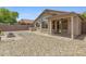 Back of house and backyard featuring patio and low-maintenance desert landscaping at 16619 W Cottonwood St, Surprise, AZ 85388