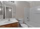Bathroom with vanity sink, mirror and standard white toilet and tub/shower combo at 16619 W Cottonwood St, Surprise, AZ 85388