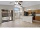 Open kitchen featuring wood cabinets, a breakfast bar, and a sliding glass door to the backyard at 16619 W Cottonwood St, Surprise, AZ 85388