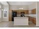 Spacious kitchen with wood cabinets, a black refrigerator, and a center island at 16619 W Cottonwood St, Surprise, AZ 85388