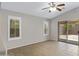Tiled living area with plantation shutters, ceiling fan and access to the backyard at 16619 W Cottonwood St, Surprise, AZ 85388