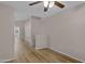 Living room featuring wood flooring, a ceiling fan, and neutral paint at 16619 W Cottonwood St, Surprise, AZ 85388