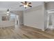 Large open-concept space with hardwood floors and views to the kitchen and entry at 16619 W Cottonwood St, Surprise, AZ 85388