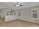 Living room with tiled floors, neutral walls, large windows and a ceiling fan at 16619 W Cottonwood St, Surprise, AZ 85388