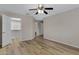 Main bedroom with walk-in closet, wood-look floors, ceiling fan and adjoining bathroom at 16619 W Cottonwood St, Surprise, AZ 85388