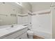 Clean bathroom with tub, toilet, and a large mirror with vanity at 1701 E Colter St # 147, Phoenix, AZ 85016