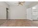Bedroom features mirrored closet, ceiling fan, tile flooring, and ensuite bathroom at 1701 E Colter St # 147, Phoenix, AZ 85016