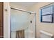 Modern shower featuring a glass door, convenient towel bar, and a tiled seat at 17349 E Quail Ridge Dr, Fountain Hills, AZ 85268