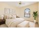 Serene bedroom featuring a plush bed, bench, and arched window with neighborhood views at 17349 E Quail Ridge Dr, Fountain Hills, AZ 85268