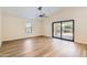Airy bedroom featuring hardwood floors, ceiling fan, and sliding glass doors to the outdoor area at 17349 E Quail Ridge Dr, Fountain Hills, AZ 85268