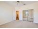 Bedroom featuring carpeted floor, a ceiling fan, and mirrored sliding doors to the closet at 17349 E Quail Ridge Dr, Fountain Hills, AZ 85268
