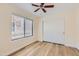 Cozy bedroom features new laminate flooring, a ceiling fan, and a double door closet for easy storage at 17349 E Quail Ridge Dr, Fountain Hills, AZ 85268