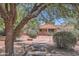 Manicured community landscape with mature trees, shrubs, and a view of the building's exterior at 17349 E Quail Ridge Dr, Fountain Hills, AZ 85268