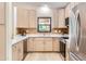 Modern kitchen features stainless steel appliances, light wood cabinets, and sleek white countertops at 17349 E Quail Ridge Dr, Fountain Hills, AZ 85268