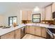 Charming kitchen featuring stainless steel appliances, light wood cabinetry, and white countertops at 17349 E Quail Ridge Dr, Fountain Hills, AZ 85268