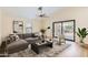 Bright living room featuring a comfortable sectional sofa and sliding glass doors to the outdoor space at 17349 E Quail Ridge Dr, Fountain Hills, AZ 85268