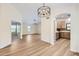 Bright open-concept living space featuring hardwood floors, modern light fixtures and an arched entry to kitchen at 17349 E Quail Ridge Dr, Fountain Hills, AZ 85268