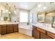 Bright bathroom with dual sinks, a large tub, and tile flooring at 18149 W Turney Ave, Goodyear, AZ 85395