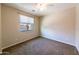 Neutral bedroom featuring plush carpeting, window with blinds, and ample natural light at 18149 W Turney Ave, Goodyear, AZ 85395