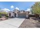 A single story home with a two car garage, desert landscaping, and a walkway to the front door at 18149 W Turney Ave, Goodyear, AZ 85395