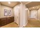 Warm foyer with a wooden console table, interior door, and tile floors offer a welcoming entrance at 18149 W Turney Ave, Goodyear, AZ 85395