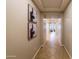 Hallway features decorative art, neutral paint, and tile flooring. Bright, spacious, and inviting at 18149 W Turney Ave, Goodyear, AZ 85395