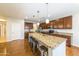 Spacious kitchen with granite counters, island seating, and ample cabinet storage at 18149 W Turney Ave, Goodyear, AZ 85395
