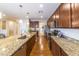 Modern kitchen featuring granite countertops, stainless steel appliances, and dark wood cabinetry at 18149 W Turney Ave, Goodyear, AZ 85395
