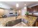 Modern kitchen featuring granite countertops, stainless steel sink, and open floor plan at 18149 W Turney Ave, Goodyear, AZ 85395